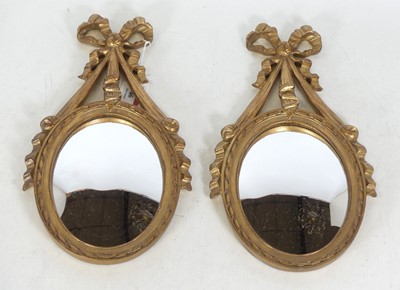 Lot 46 - A pair of reproduction gilt composite mirrors,...