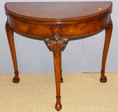 Lot 721 - A 1920s figured walnut demi-lune fold-over...