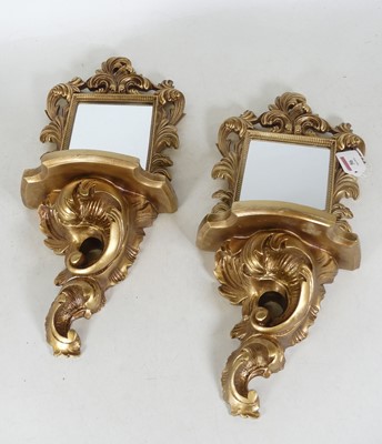 Lot 56 - A pair of reproduction gilt composite mirrored...