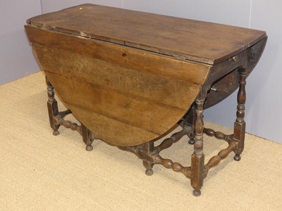 Lot 718 - An 18th century oak drop-leaf dining table,...
