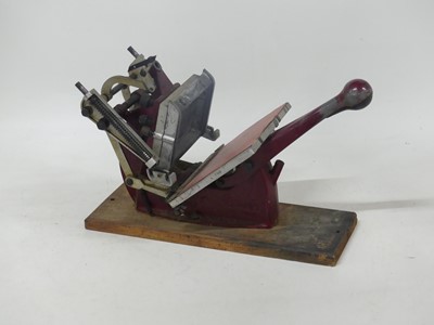 Lot 587 - An Adana printing press together with a...