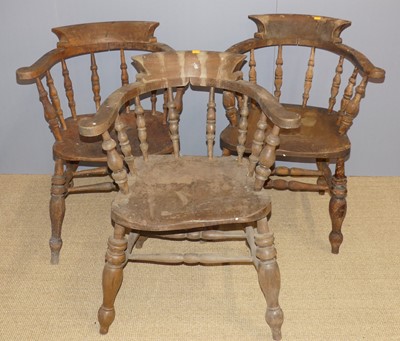 Lot 689 - Three similar elm and beech tub captains chairs