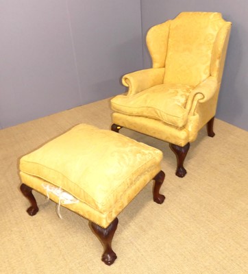 Lot 692 - A yellow floral fabric upholstered wingback...