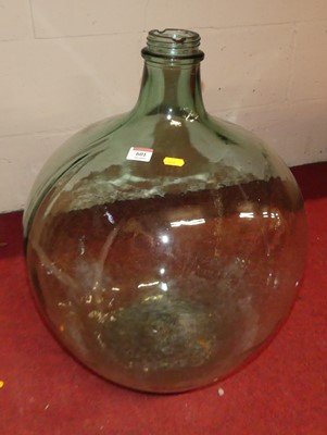 Lot 601 - A green tinted and moulded glass carboy, h.56cm