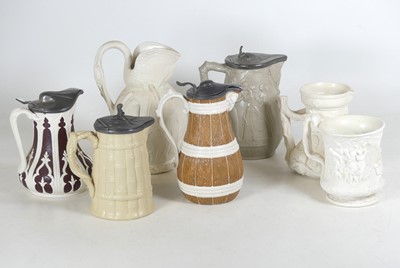 Lot 142 - A collection of relief moulded jugs, to...