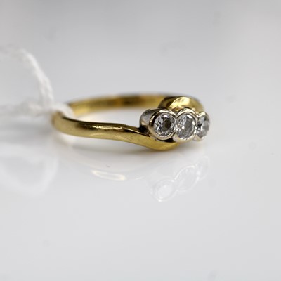 Lot 300 - An 18ct gold diamond trilogy ring, total...
