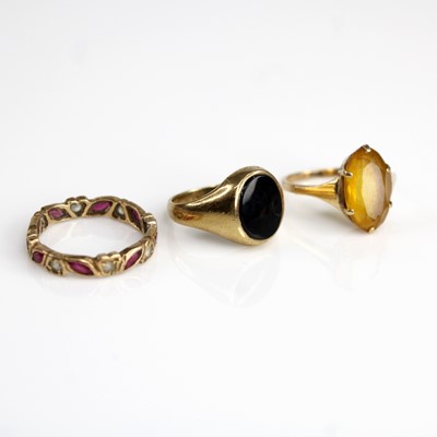 Lot 305 - Three 9ct gold dress rings, to include a black...