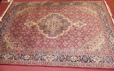 Lot 743 - A Persian woollen red, blue and cream ground...