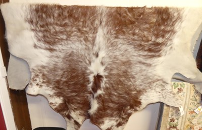 Lot 754 - A contemporary hide skin rug, with shaped outline