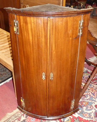 Lot 762 - A George III mahogany bowfront double door...