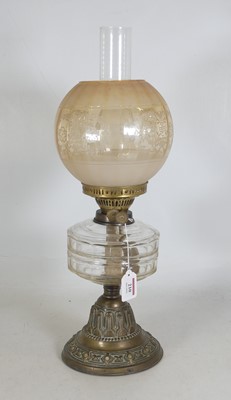Lot 210 - An early 20th century oil lamp, having an acid-...