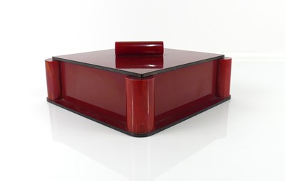 Lot 20 - An Art Deco rouge bakelite square table box...