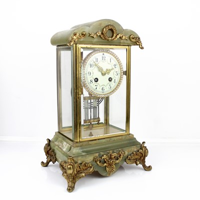 Lot 54 - An early 20th century gilt brass and onyx...