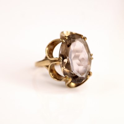 Lot 238 - A 9ct yellow gold oval smoky quartz dress ring,...