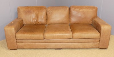 Lot 693 - A contemporary tan leather upholstered...
