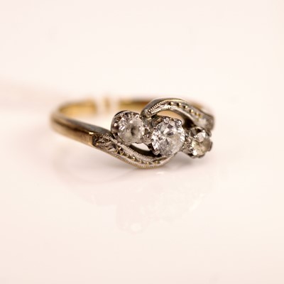 Lot 232 - A yellow and white metal three-stone crossover...