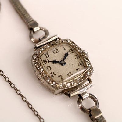 Lot 235 - A white metal lady's manual wind diamond...