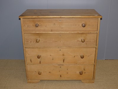 Lot 662 - A rustic pine square front chest of four long...