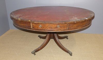 Lot 641 - A mahogany oval rent table, having red leather...