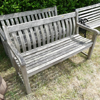 Lot 594 - A pair of teak garden benches