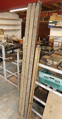 Lot 680 - Three surveyors' telescopic rules; together...