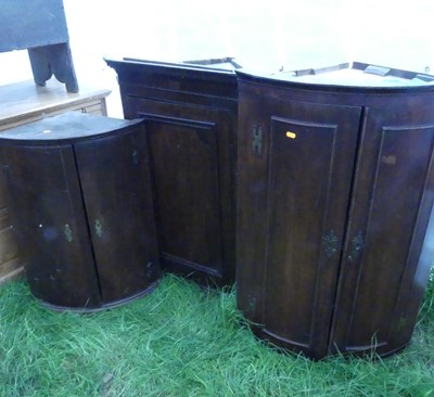 Lot 771 - A George III oak hanging corner cupboard;...