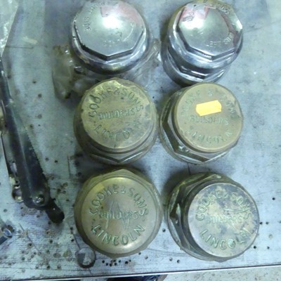 Lot 915 - A set of four early brass hub caps, annotated...