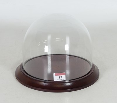 Lot 17 - A reproduction glass dome, on moulded mahogany...