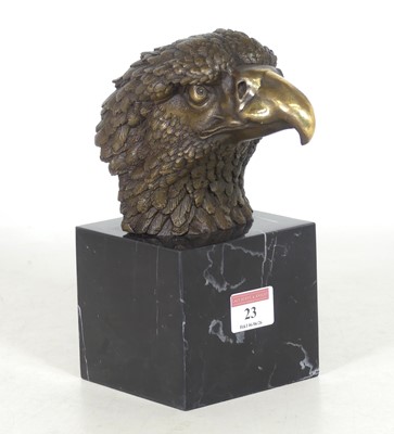 Lot 23 - A reproduction bronze eagle head, mounted to a...