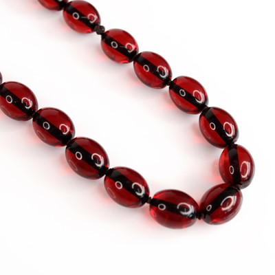 Lot 252 - A faux cherry amber bead necklace, each bead...