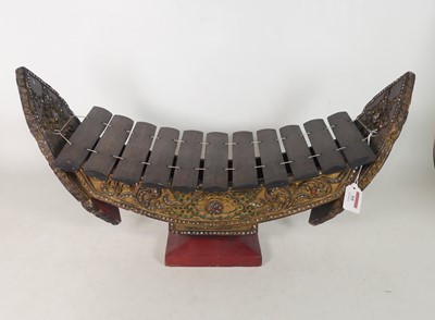 Lot 55 - A Thai Ranat Ek wooden xylophone, on a carved...