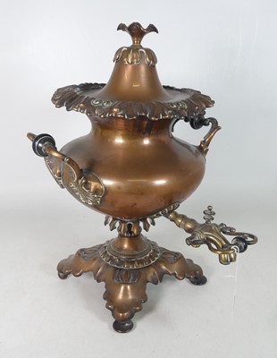Lot 53 - A 19th-century copper samovar, flanked by...