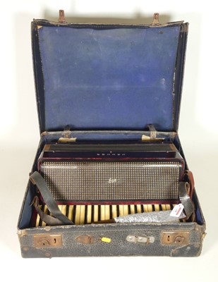 Lot 68 - A Hohner accordion, having a burgundy case, in...