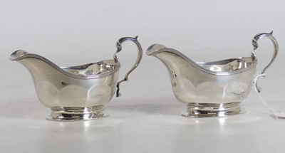 Lot 231a - A pair of George V silver sauceboats, of...