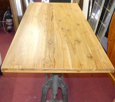 Lot 611 - A blond oak topped and cast iron based...