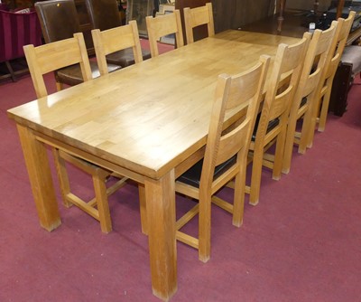 Lot 632 - A contemporary blond oak dining suite,...