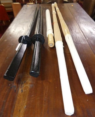 Lot 633 - Two black painted Japanese style dummy swords...