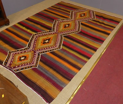 Lot 743 - An Anatolian kilim rug, bright-coloured ground,...