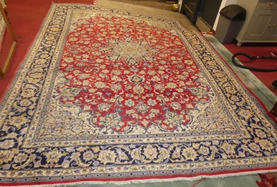 Lot 746 - A Persian woollen red, blue and cream ground...