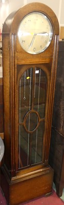 Lot 679 - A 1930s oak dome top long case clock, having a...