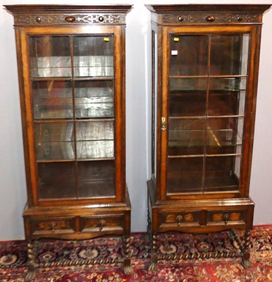 Lot 717 - A pair of 1920s oak single door glazed china...