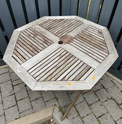 Lot 760 - A slatted teak octagonal X-framed folding...