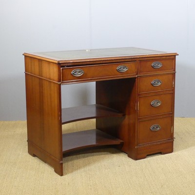 Lot 645 - A contemporary mahogany kneehole writing desk,...