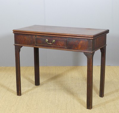 Lot 650 - A George III mahogany tea table, having a fold-...