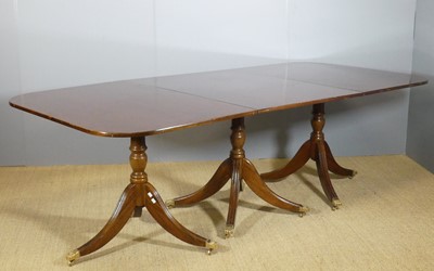Lot 701 - A mahogany triple pedestal dining table, in...