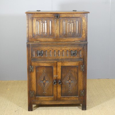 Lot 639 - An oak linen fold cocktail cabinet, with...