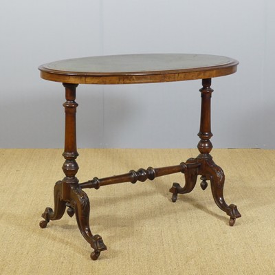 Lot 689 - A mid-Victorian walnut and gilt tooled green...