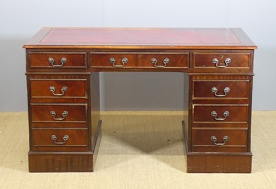 Lot 691 - A contemporary mahogany and gilt tooled red...