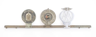 Lot 12 - A collection of three car badges to include...