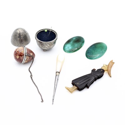 Lot 237 - An early 20th century pewter egg-shaped pin...